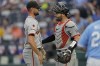 San Francisco Giants relief pitcher Tristan Beck, left, and catcher Curt Casali celebrate after their baseball game against the Kansas City Royals Saturday, Sept. 21, 2024, in Kansas City, Mo. The Giants won 9-0. (AP Photo/Charlie Riedel)
