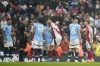 Arsenal's Leandro Trossard, right, reacts after getting a red card during the English Premier League soccer match between Manchester City and Arsenal at the Etihad stadium in Manchester, England, Sunday, Sept. 22, 2024. (AP Photo/Dave Thompson)