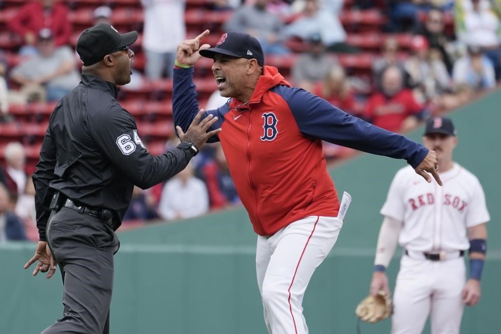 Boston Red Sox manager Alex Cora argues with umpire Alan Porter (64) after being ejected during the first inning of the first game of a baseball doubleheader against the Minnesota Twins, Sunday, Sept. 22, 2024, in Boston. (AP Photo/Michael Dwyer)