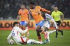 Marseille's Elye Wahi, center, challenges Lyon's Duje Caleta-Car, left, for the ball with during a French League One soccer match at the Groupama stadium in Decines, outside Lyon, France, Sunday, Sept. 22, 2024. (AP Photo/Laurent Cipriani)