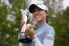 Lydia Ko, of New Zealand, poses for photos with the trophy and a golf ball after winning the LPGA Kroger Queen City Championship golf tournament at TPC River's Bend in Maineville, Ohio, Sunday, Sept. 22, 2024. (AP Photo/Carolyn Kaster)