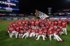 The Philadelphia Phillies pose for a photo after winning a baseball game against the Chicago Cubs to clinch the NL East title, Monday, Sept. 23, 2024, in Philadelphia. (AP Photo/Matt Slocum)