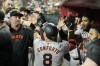 San Francisco Giants' Michael Conforto (8) celebrates after his home run against the Arizona Diamondbacks with coaches and teammates during the fifth inning of a baseball game Monday, Sept. 23, 2024, in Phoenix. (AP Photo/Ross D. Franklin)