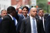 Prime Minister Justin Trudeau, flanked by entourage and security, waves as he arrives to the CBS studios for the filming of 