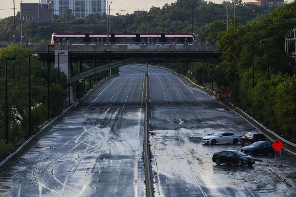 The Insurance Bureau of Canada estimates over seven billion dollars in insured losses following four catastrophic weather events this summer. Cars remain stranded on the Don Valley Parkway as water recedes following heavy rain that caused flooding in Toronto on Tuesday, July 16, 2024. THE CANADIAN PRESS/Christopher Katsarov