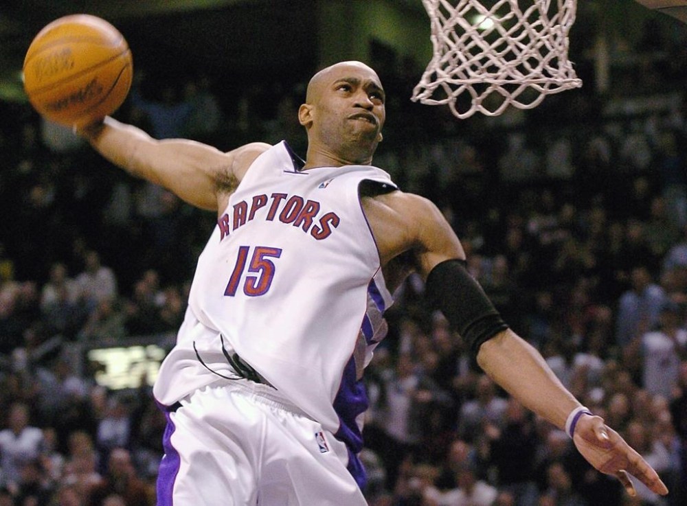 Former Toronto Raptors star Vince Carter will have his No. 15 retired by the NBA team this season, according to multiple media reports. Carter jams during second-half NBA action against the Cleveland Cavaliers, in Toronto on Wednesday, Jan. 7, 2004. THE CANADIAN PRESS/Aaron Harris