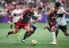 Toronto FC's Federico Bernardeschi, front left, and Vancouver Whitecaps' Andres Cubas vie for the ball during first half MLS soccer action in Vancouver, B.C., Saturday, April 6, 2024. THE CANADIAN PRESS/Darryl Dyck