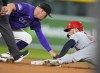 Colorado Rockies second baseman Aaron Schunk, left, applies a late tag as St. Louis Cardinals' Michael Siani steals second base in the third inning of a baseball game Tuesday, Sept. 24, 2024, in Denver. (AP Photo/David Zalubowski)