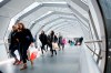 Statistics Canada says the population of the country reached an estimated 41,288,599 on July 1. People walk in an overhead pedestrian crossing in Toronto on Thursday, Dec. 26, 2019. THE CANADIAN PRESS/Cole Burston