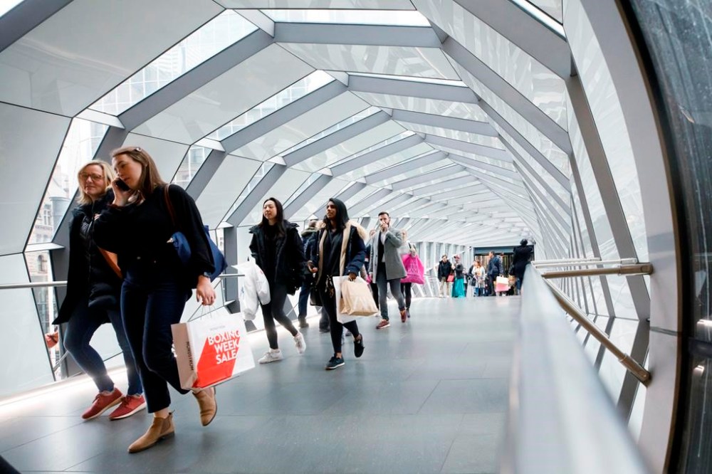 Statistics Canada says the population of the country reached an estimated 41,288,599 on July 1. People walk in an overhead pedestrian crossing in Toronto on Thursday, Dec. 26, 2019. THE CANADIAN PRESS/Cole Burston