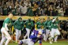 Oakland Athletics players pour out of the dugout to celebrate after defeating the Texas Rangers 5-4 on a walk-off RBI single by Jacob Wilson in the ninth inning of a baseball game at the Coliseum in Oakland, Calif., on Tuesday, Sept. 24, 2024. (Carlos Avila Gonzalez/San Francisco Chronicle via AP)