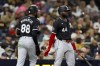 Chicago White Sox's Luis Robert Jr., left, celebrates with designated hitter Bryan Ramos after scoring off a single hit by Lenyn Sosa during the sixth inning of a baseball game against the San Diego Padres, Saturday, Sept. 21, 2024, in San Diego. (AP Photo/Ryan Sun)