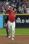 Cleveland Guardians' Steven Kwan celebrates his home run as he runs the bases in the first inning of a baseball game against the Cincinnati Reds in Cleveland, Wednesday, Sept. 25, 2024. (AP Photo/Sue Ogrocki)