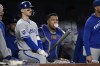 Kansas City Royals' Bobby Witt Jr., left, and catcher Salvador Perez, right, look on from the dugout during the fourth inning of a baseball game against the Washington Nationals, Wednesday, Sept. 25, 2024, in Washington. (AP Photo/Nick Wass)
