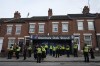 FILE - Police gather outside the Oak Stand entrance to Luton Town ahead of the English Premier League soccer match between Luton Town against West Ham United, in Luton, England, Friday, Sept. 1, 2023. (AP Photo/Frank Augstein, File)