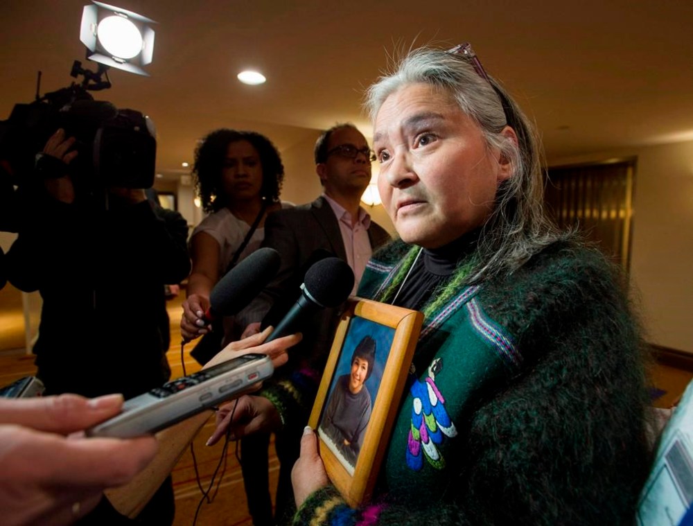 Elisapee Sheutiapik, former mayor of Iqaluit, holds a photo of Mary Ann Birmingham, who was 15 when she was murdered in Iqaluit in 1986, at the National Roundtable on Missing and Murdered Indigenous Women and Girls in Ottawa on Friday, Feb. 27, 2015. THE CANADIAN PRESS/Justin Tang