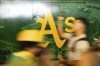 Fans move through the Oakland Coliseum before a baseball game between the Oakland Athletics and the Texas Rangers Thursday, Sept. 26, 2024, in Oakland, Calif. (AP Photo/Benjamin Fanjoy)
