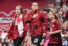 Canada's national women's soccer team captain Christine Sinclair reacts as she walks onto the field with her nieces Kaitlyn and Kenzie to be honoured before playing a friendly against Australia in her final international soccer match in Vancouver on Tuesday, December 5, 2023. THE CANADIAN PRESS/Darryl Dyck