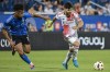 New England Revolution's Carles Gil, right, breaks away from CF Montreal's Nathan Saliba (19) during second half MLS soccer action in Montreal, Saturday, August 24, 2024. THE CANADIAN PRESS/Graham Hughes