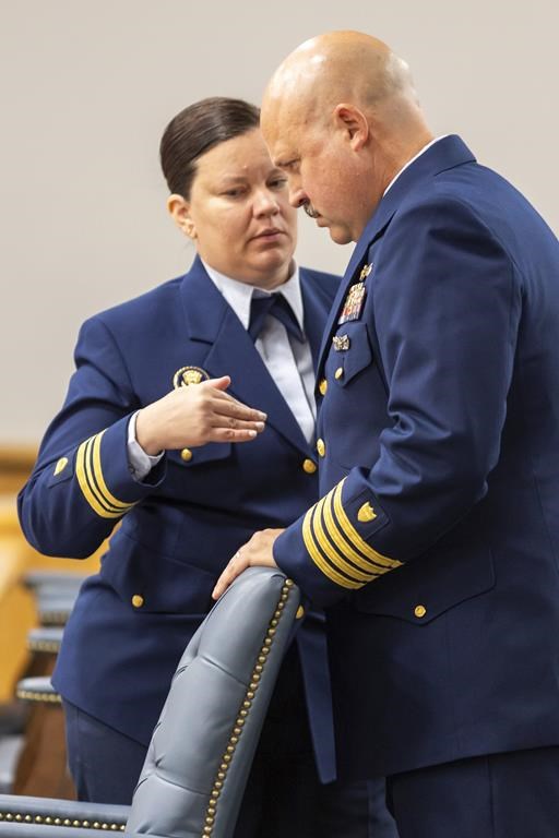Jamie Frederick, at right, with the U.S. Coast Guard Sector Boston, speaks with Coast Guard legal counsel Jessie Brenton during a break during the final day of the Coast Guard investigatory hearing on the causes of the implosion of an experimental submersible headed for the wreck of the Titanic, Friday, Sept. 27, 2024, in North Charleston, S.C. (AP Photo/Mic Smith)