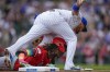 Cincinnati Reds' Elly De La Cruz, left, is tagged out at third base by Chicago Cubs third baseman Isaac Paredes during the first inning of a baseball game Friday, Sept. 27, 2024, in Chicago. (AP Photo/Erin Hooley)