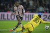 PSG's Bradley Barcola, left, scores his side's third goal during the French League One soccer match between Paris Saint-Germain and Rennes at the Parc des Princes in Paris, Friday, Sept. 27, 2024. (AP Photo/Thibault Camus)