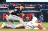 Toronto Blue Jays' Jonatan Clase (right) is tagged out at third base by Miami Marlins third baseman Connor Norby (24) during second inning interleague MLB baseball action in Toronto, Friday, Sept. 27, 2024. THE CANADIAN PRESS/Chris Young