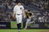 New York Yankees starting pitcher Carlos Rodon, foreground, reacts after giving up a home run to Pittsburgh Pirates' Bryan Reynolds during the sixth inning of a baseball game Friday, Sept. 27, 2024, in New York. (AP Photo/Adam Hunger)