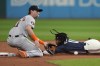 Cleveland Guardians' Jose Ramirez, right, steals second base as Houston Astros third baseman Grae Kessinger, left, takes the throw in the first inning of a baseball game in Cleveland, Friday, Sept. 27, 2024. (AP Photo/Sue Ogrocki)