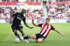 West Ham United's Michail Antonio (left) and Brentford's Ethan Pinnock battle for the ball during the British Premier League soccer match between West Ham and Brentford, at the Gtech Community Stadium, London, Saturday Sept. 28, 2024. (Rhianna Chadwick/PA via AP)