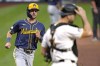 Milwaukee Brewers' Sal Frelick, left, scores the second of two runs driven in on a single by Joey Ortiz, as Pittsburgh Pirates catcher Joey Bart looks away during the second inning of a baseball game in Pittsburgh, Tuesday, Sept. 24, 2024. (AP Photo/Gene J. Puskar)