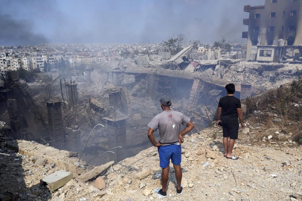 People check a damaged building at the site of an Israeli airstrike in Choueifat, south east of Beirut, Saturday, Sept. 28, 2024. Canada is contributing $10 million for humanitarian assistance for civilians in Lebanon amid the escalating conflict between Israel and Hezbollah. THE CANADIAN PRESS/AP, Hussein Malla