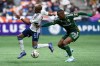 Vancouver Whitecaps' Fafa Picault, left, and Portland Timbers' Juan David Mosquera, right, vie for the ball during the first half of an MLS soccer match in Vancouver, on Saturday, Sept. 28, 2024. THE CANADIAN PRESS/Ethan Cairns