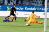 Frankfurt's Omar Marmoush, centre, scores his side's third goal past Kiel's Carl Johansson, left, and goalkeeper Timon Weiner during the Bundesliga soccer match between Holstein Kiel and Eintracht Frankfurt, at the Holstein Stadium in Kiel, Germany, Sunday, Sept. 29, 2024. (Frank Molter/dpa via AP)