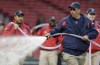 FILE - Boston Red Sox groundskeeper Dave Mellor waters the field prior to a baseball game at Fenway Park in Boston, April 28, 2016. (AP Photo/Charles Krupa, file)