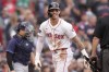 Boston Red Sox outfielder Jarren Duran, center, smiles after scoring on a Tampa Bay Rays error after teammate Vaughn Grissom hit a double in the third inning of a baseball game Sunday, Sept. 29, 2024, in Boston. (AP Photo/Steven Senne)