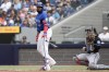 Toronto Blue Jays designated hitter Vladimir Guerrero Jr. tosses his bat after being walked by Miami Marlins pitcher Ryan Weathers as catcher Nick Fortes during first inning interleague MLB baseball action in Toronto, Sunday, Sept. 29, 2024. THE CANADIAN PRESS/Chris Young