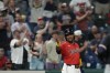 Fans cheer behind Cleveland Guardians' José Ramírez at third base during a baseball game against the Minnesota Twins Tuesday, Sept. 17, 2024, in Cleveland. (AP Photo/Sue Ogrocki)