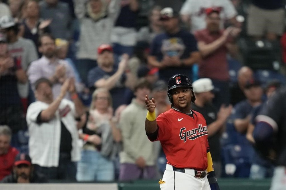 Fans cheer behind Cleveland Guardians' José Ramírez at third base during a baseball game against the Minnesota Twins Tuesday, Sept. 17, 2024, in Cleveland. (AP Photo/Sue Ogrocki)