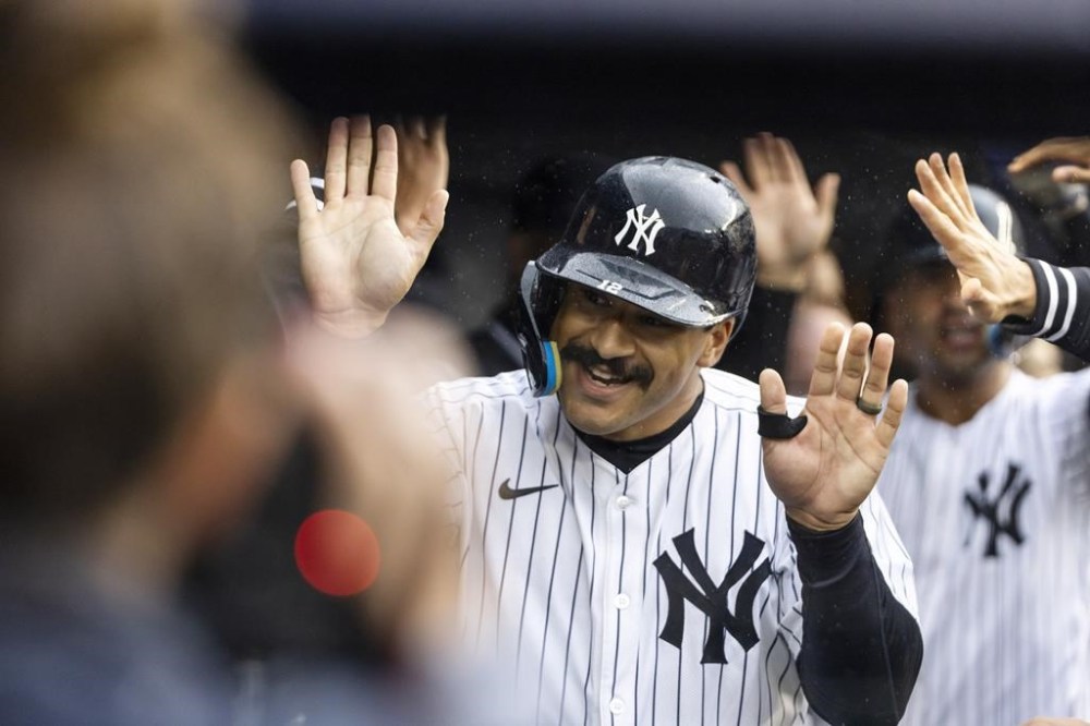 New York Yankees Trent Grisham, right celebrates his double home run with teammates at the dougout during the first inning of a baseball game against the Pittsburgh Pirates, Sunday, Sept. 29, 2024, in New York. (AP Photo/Eduardo Munoz Alvarez)
