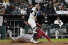 Los Angeles Angels' Eric Wagaman (34) is safe at home plate as Chicago White Sox catcher Korey Lee, right, stands nearby during eighth inning of a baseball game, Wednesday, Sept. 25, 2024, in Chicago. (AP Photo/David Banks)