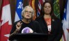 The Survivors' Secretariat Executive Lead Laura Arndt, right, looks on as survivor of the Mohawk Institute and Secretariat board member Roberta Hill speaks during a news conference on Parliament Hill, in Ottawa, Monday, Sept. 30, 2024. THE CANADIAN PRESS/Adrian Wyld