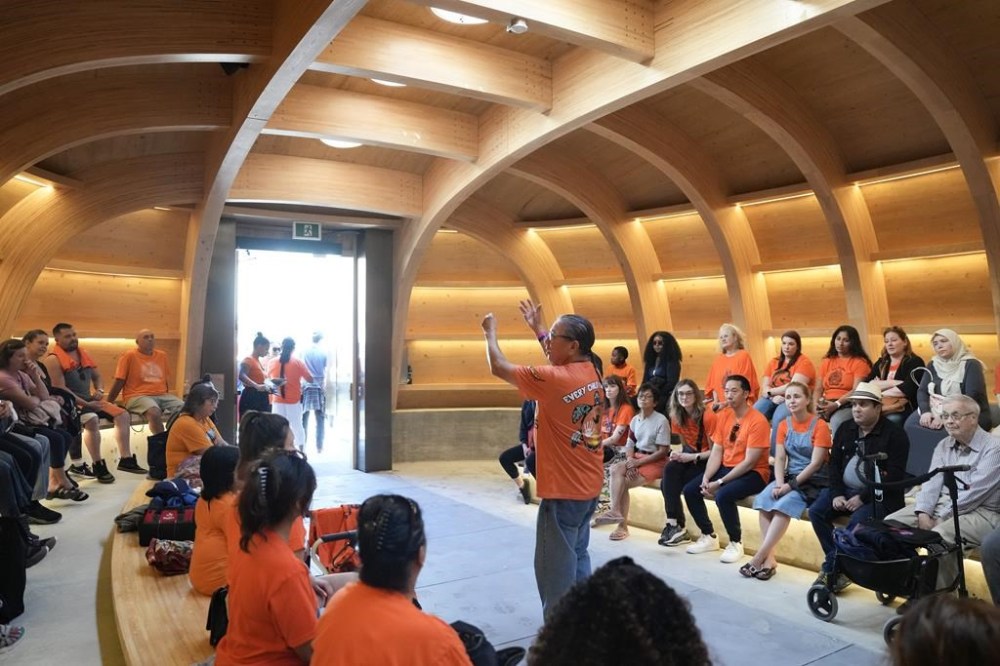 John Keeshig, who's spirit name is Maya-Waasige, talks to visitors in the Teaching Lodge situated in Nathan Phillips Square, in Toronto, Monday, Sept. 30, 2024. The Lodge is designed to reinforce the importance of family, represents life's journey and is a spiritual home for all First Nation People. THE CANADIAN PRESS/Chris Young