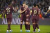 Manchester City's Phil Foden, center, celebrates after scoring his side's second goal during the Champions League opening phase soccer match between Slovan Bratislava and Manchester City in Bratislava, Slovakia, Tuesday, Oct. 1, 2024. (AP Photo/Petr Josek)