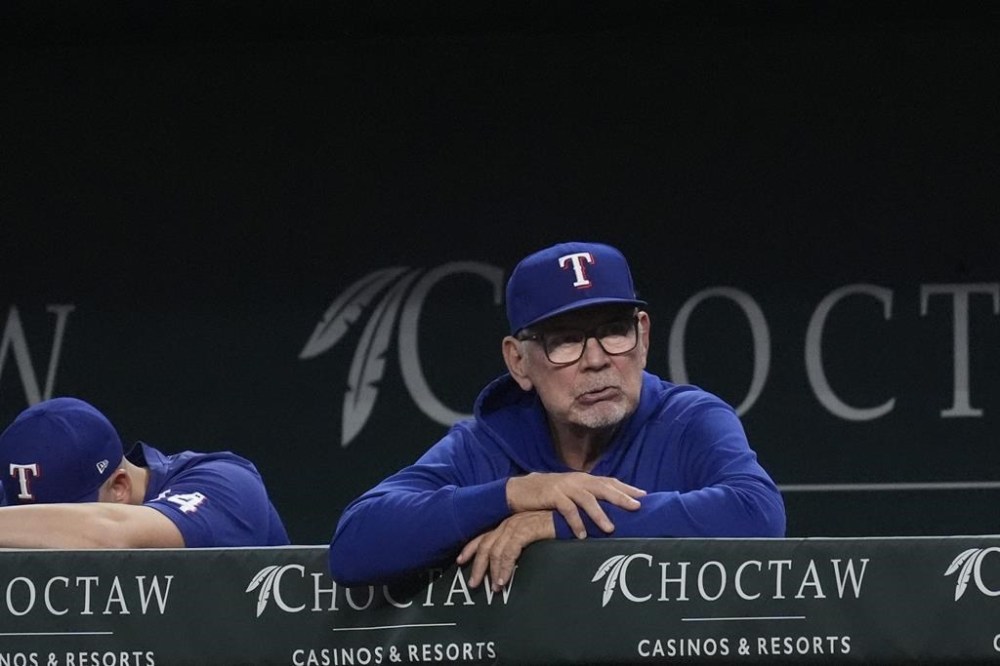 Texas Rangers manager Bruce Bochy looks on from the dugout during the second inning of a baseball game against the Seattle Mariners, Saturday, Sept. 21, 2024, in Arlington, Texas. (AP Photo/LM Otero)