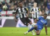 Newcastle United's Joe Willock, left, and AFC Wimbledon's Josh Neufville, right, challenge for the ball during the League Cup third round match between Newcastle United and AFC Wimbledon in Newcastle, England, Tuesday, Oct. 1, 2024. (Owen Humphreys/PA via AP)