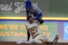 uMilwaukee Brewers' Brice Turang reacts in front of New York Mets' Jose Iglesias afterr hitting a double during the first inning of Game 1 of a National League wild card baseball game Tuesday, Oct. 1, 2024, in Milwaukee. (AP Photo/Morry Gash)