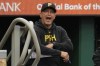FILE - Pittsburgh Pirates hitting coach Andy Haines has words for umpire Stu Scheurwater during the first inning of a baseball game against the Colorado Rockies in Pittsburgh, May 4, 2024. (AP Photo/Gene J. Puskar, File)