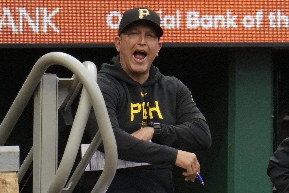 FILE - Pittsburgh Pirates hitting coach Andy Haines has words for umpire Stu Scheurwater during the first inning of a baseball game against the Colorado Rockies in Pittsburgh, May 4, 2024. (AP Photo/Gene J. Puskar, File)