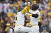 San Diego Padres' Kyle Higashioka, right, celebrate his solo home run with Luis Arraez during the second inning in Game 2 of an NL Wild Card Series baseball game against the Atlanta Braves, Wednesday, Oct. 2, 2024, in San Diego. (AP Photo/Gregory Bull)